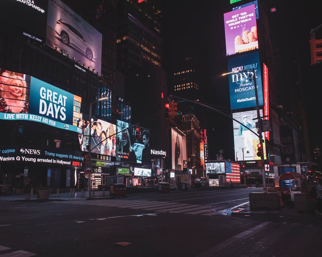 city street with high rise buildings during night time